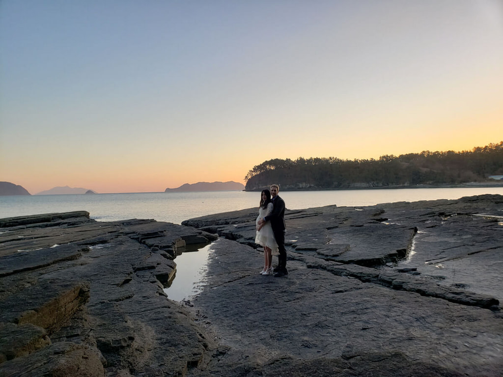 Pregnant at open rocky seaside