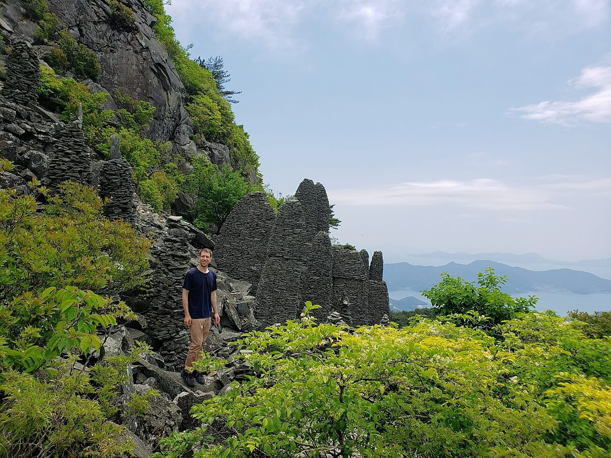 Nate standing near rock formations on Byeogbangsan
