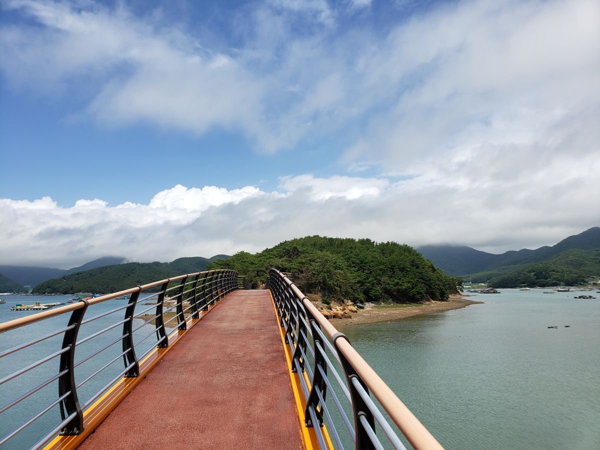 A pedestrian bridge leading to Boli Island in Goseong, Korea, on a sunny day