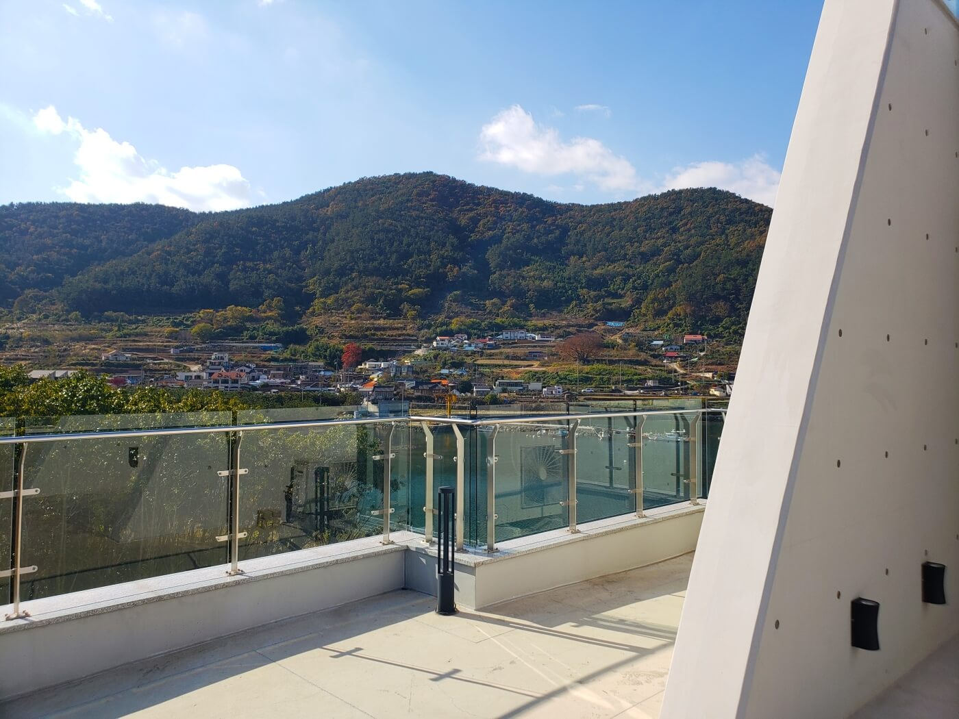 A countryside town at the base of a small mountain viewed from a café balcony in Goseong, Gyeongsangnamdo, Korea