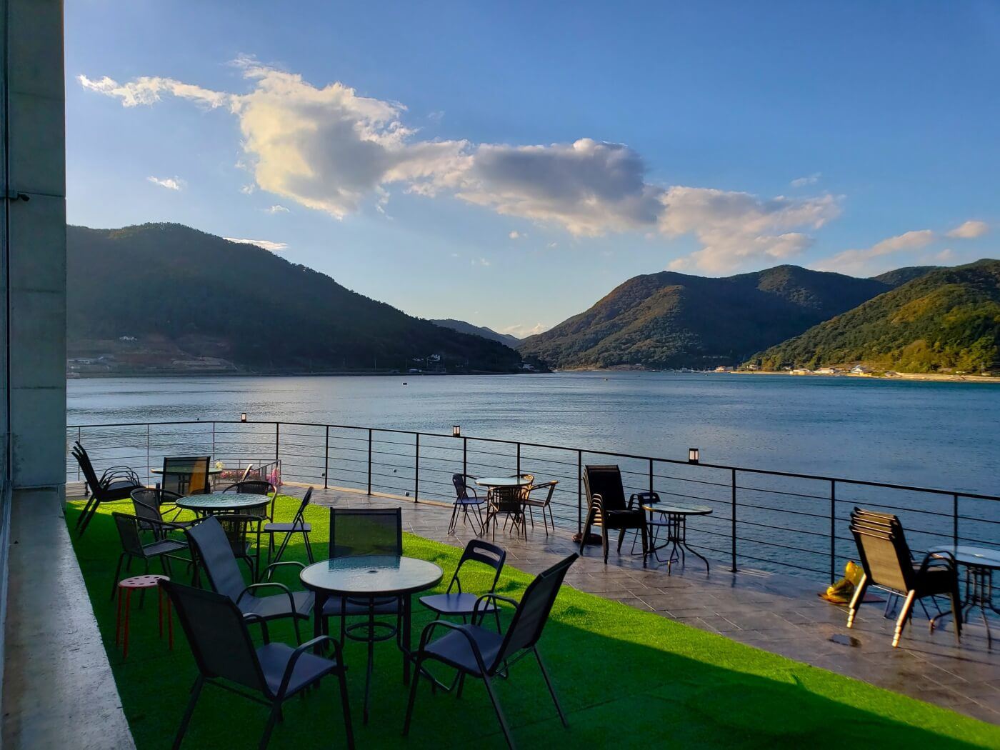 Outdoor seating around sunset with mountains and sea