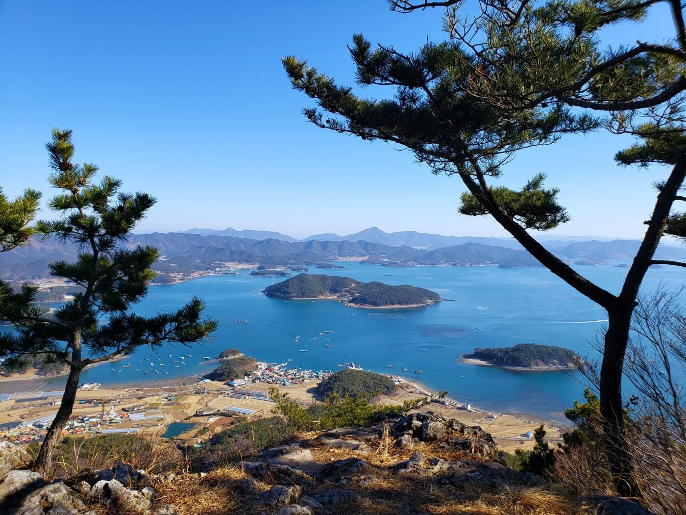 View of islands in the sea just a bit out from a village