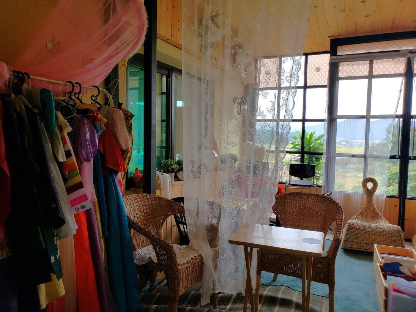 A room with traditional Korean hanbok clothes at Ludia village café