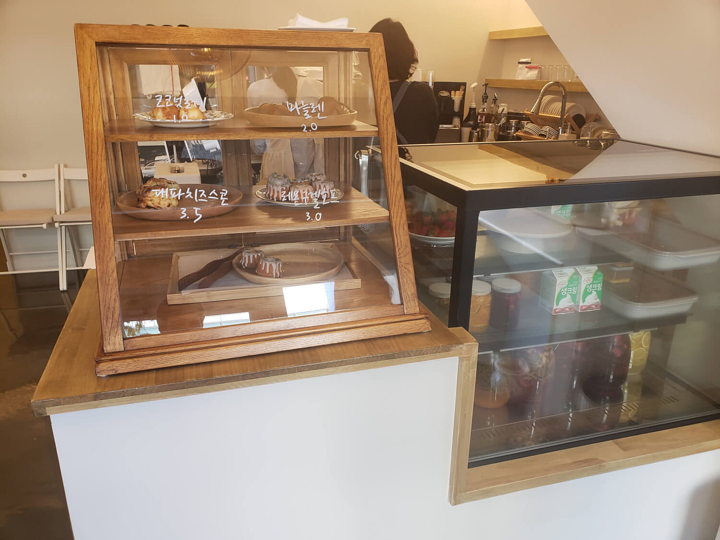 European style pastries in on wooden enclosed shelves