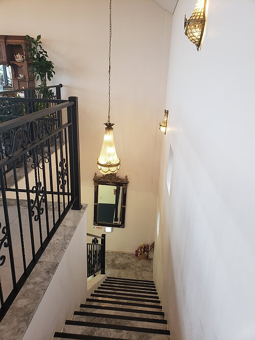 Stairs leading to the second floor with a light dangling down