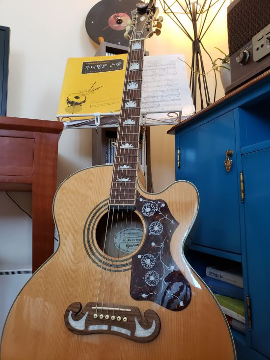 An acoustic guitar with inlay in a café