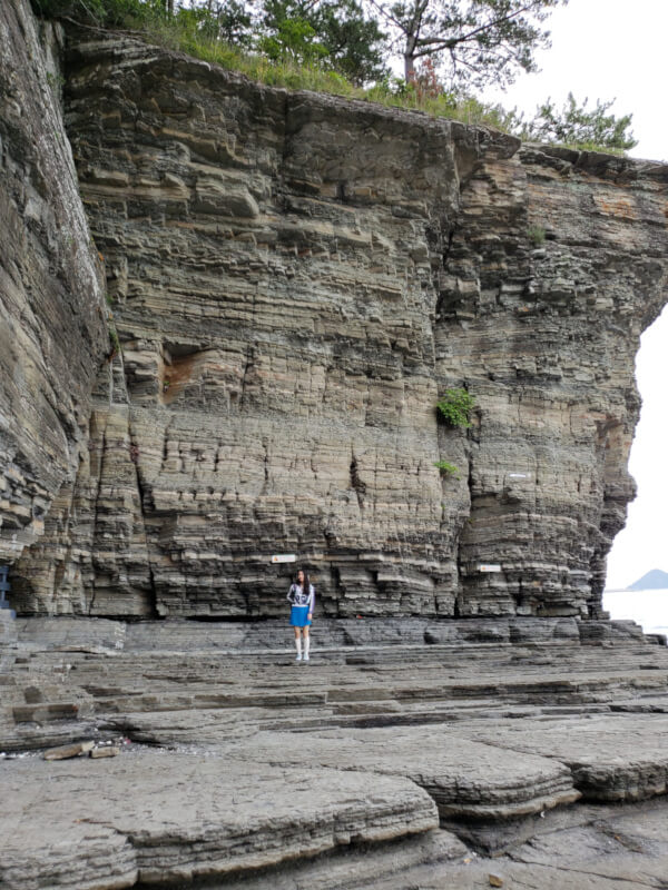 Alice standing against the cliff
