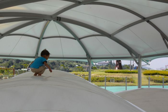 A toddler jumping on a white jumping pit