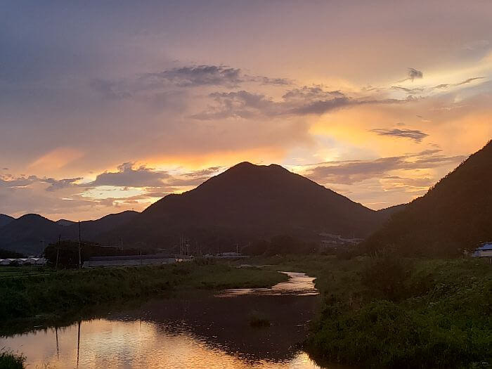 Sunset and mountains reflecting off the water near Jangsan Forest