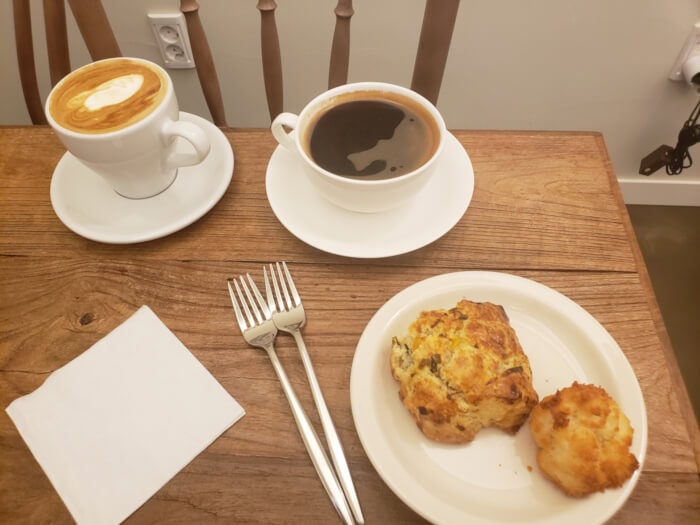 Coffee with a scone biscuit and coconut macaroon