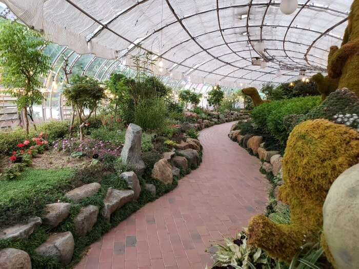 A brick path leading through the botanical garden