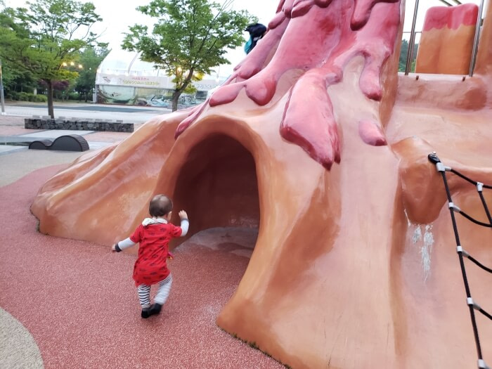 Baby noah walking into a small cave at a playground in Goseong