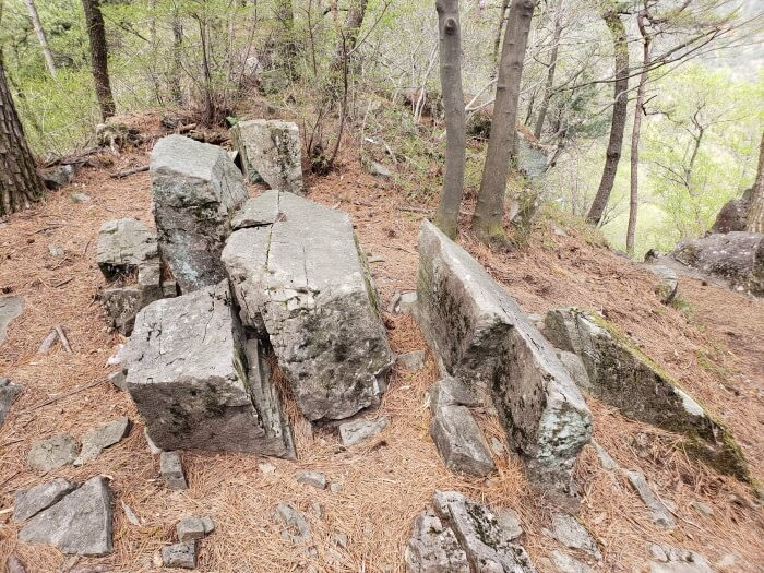 Rocks jutting out from the ground that look as if they were cut down the middle