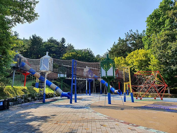 A playground with rope bridges and things to climb