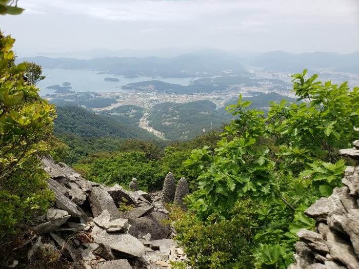 View of the rock structures from above with the town and islands below