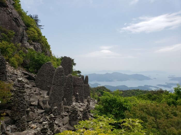 Man-made rock structures on Byeogbangsan mountainside overlooking the sea with scattered islands and peninsulas