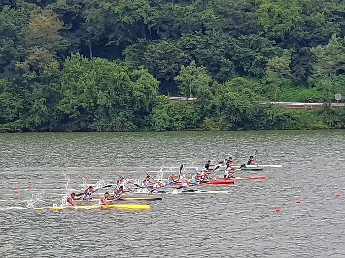 Kayakers or canoers racing down their lanes