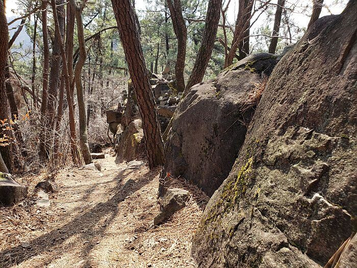 Large rocks bordering the path