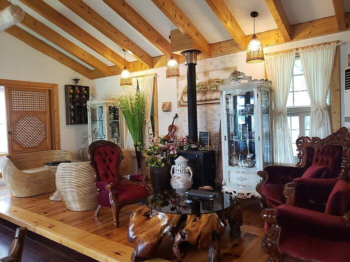 Interior of Daehuijae Café with wooden beams in the roof and nice furniture