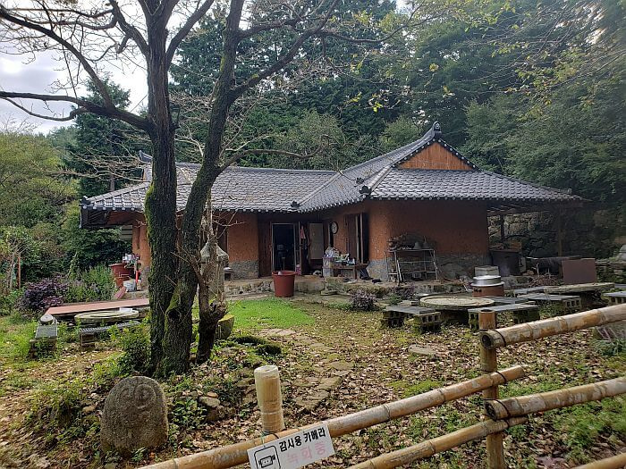 Interesting house with circular tables set up in the yard within a fence