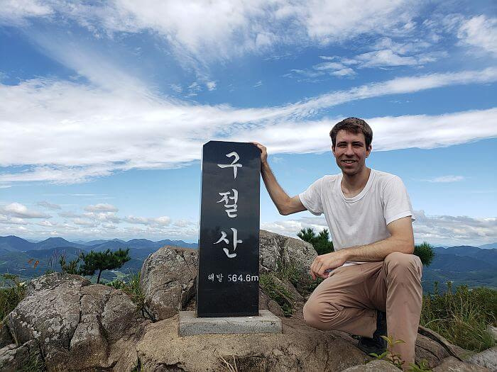 Nate next to Gujeolsan Mountain headstone
