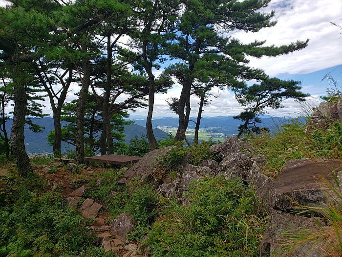 A wooden platform near a mountain peak with a nice view