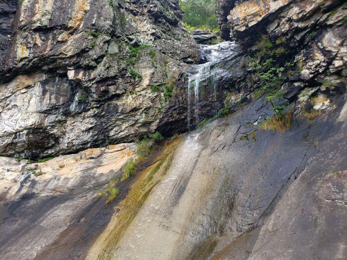 A small waterfall down a sloped rock