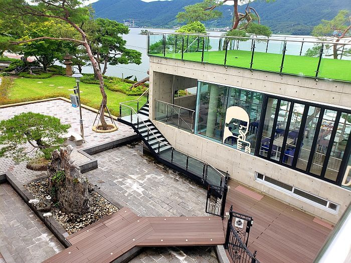 A tree and a rock on an outdoor deck