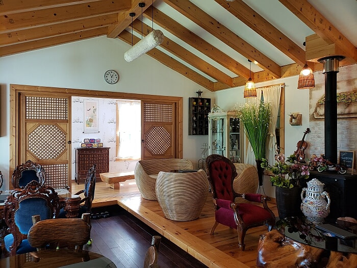 Korean café interior design wooden beams overhead and ornate furniture and Korean-style doors