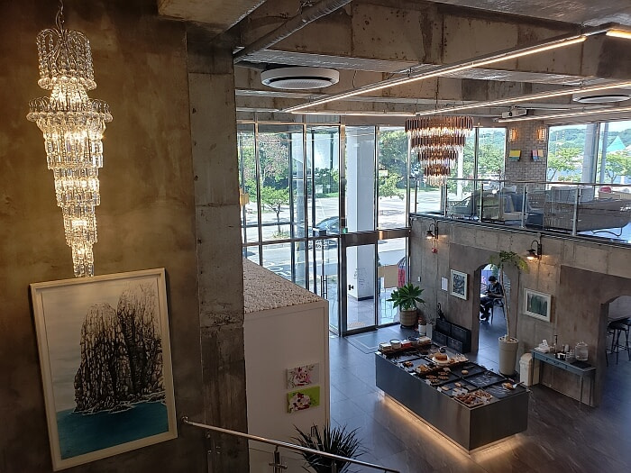 Korean café interior design nice chandelier above stairs and pastries below on first floor