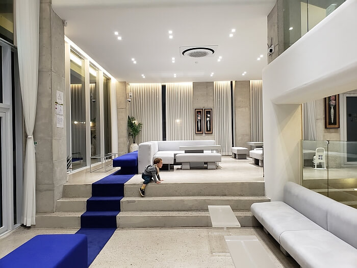 Korean café interior design a single blue strip in the carpet with padded couches and coffee tables