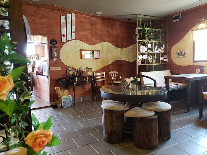 The interior of a café with large seats like stumps