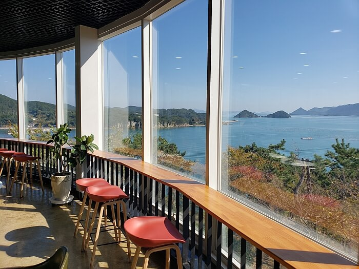 Seats along an observatory window overlooking the sea and islands