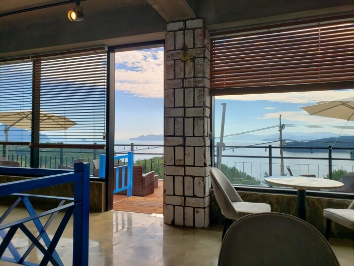 Second floor indoor seats of The Wave Café in Goseong and the entrance to the outdoor terrace