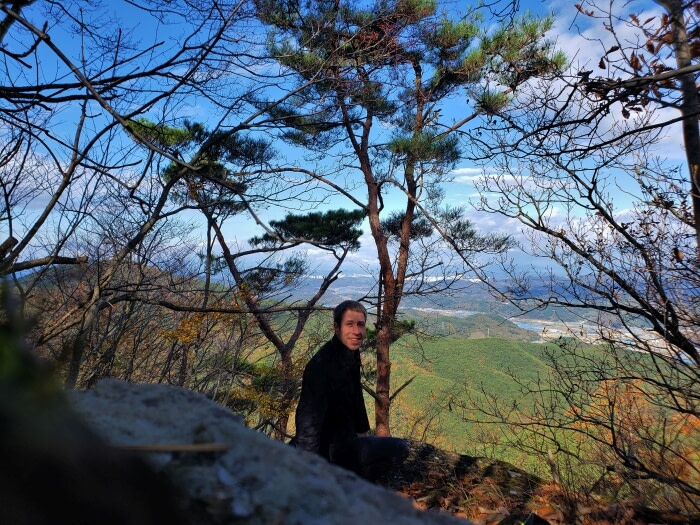 Goseong Guy Nate sitting on a rock with a nice view at Yeonhwasan Peak 1