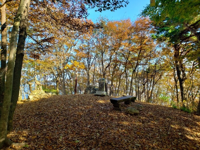 Stone benches and autumn trees at Yeonhwasan Peak