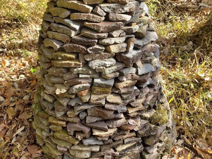 Closeup of stone pagodas in a clearing in a forest