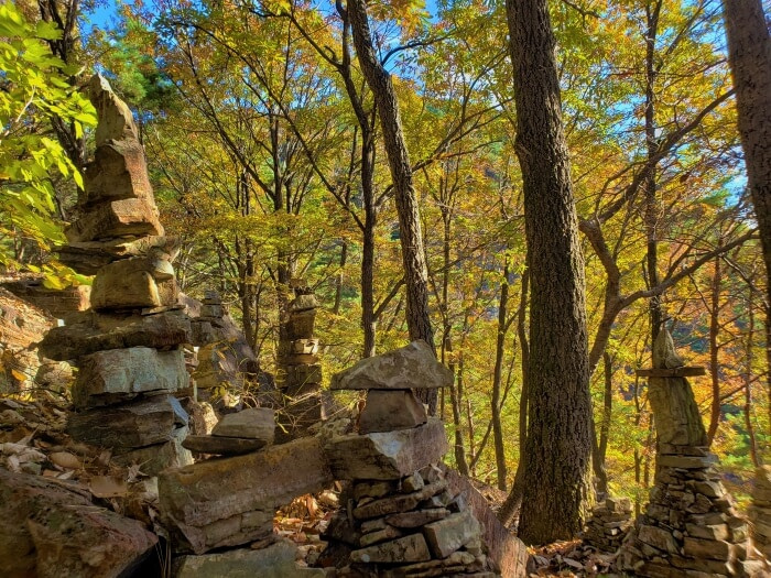 Stacks of rocks against colorful autumn trees