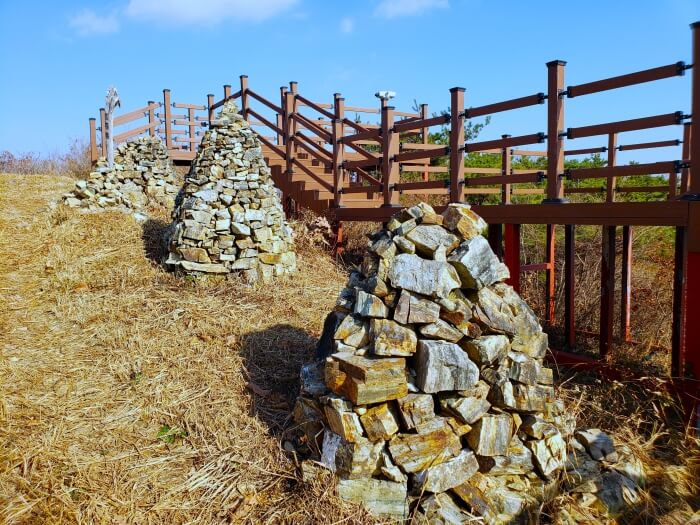 Stone pagodas along a wooden deck
