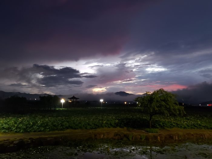 A misty sunset with a pavilion partially obstructed