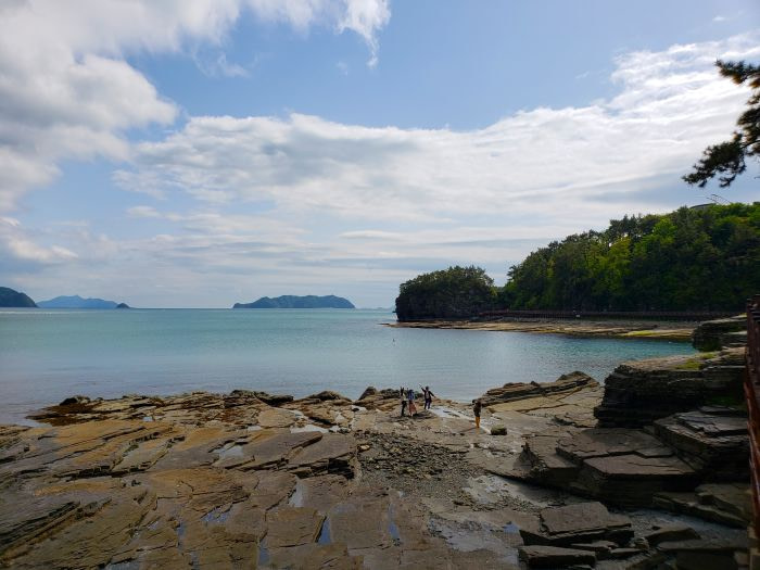 The calm sea at Sangjogam Park seen from the rocky shore