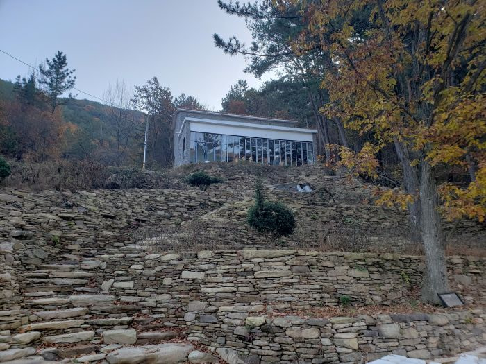 Stacks of flat stones leading up to a building