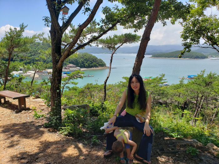 Alice and Noah on a bench on Boli Island in Goseong, South Korea