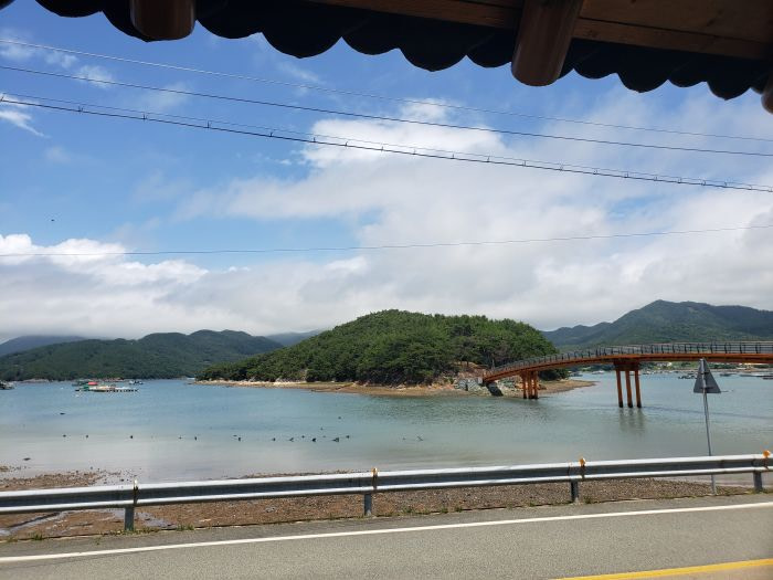 The orange bridge the leads to Boli Island on a summer day.