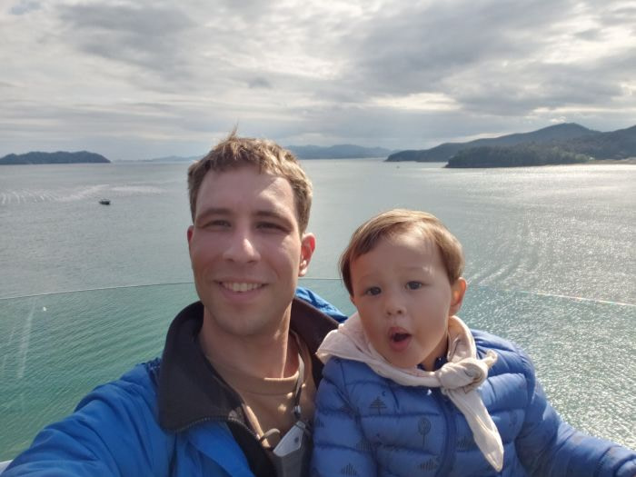Noah and Nate on an observation deck facing the sea and islands