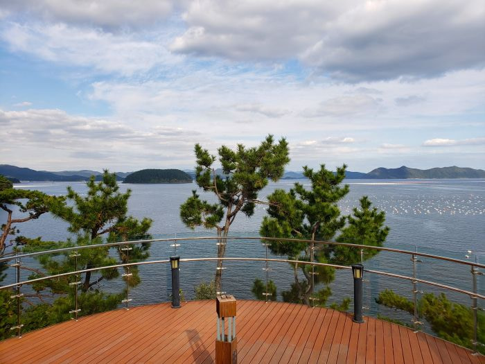 A view of the sea and mountainous islands from a glass wall