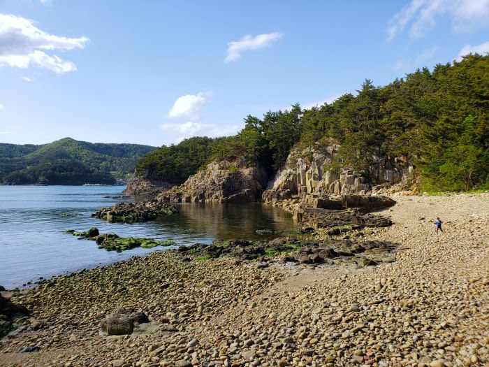A toddler on a rocky beach in Korea
