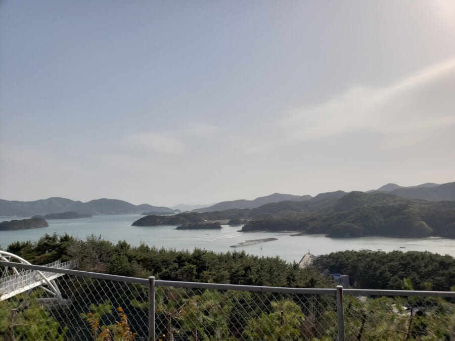 View of water and island by white bridge