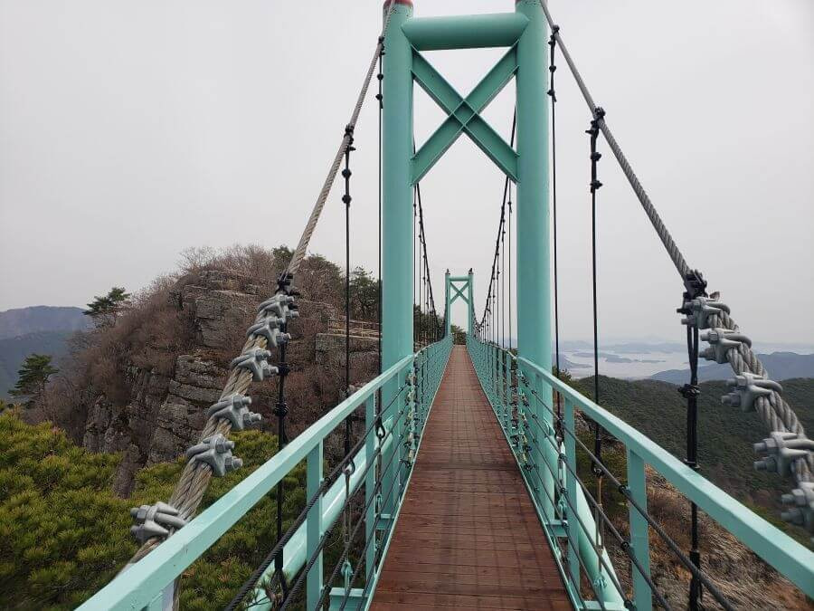 Looking down the blue suspension bridge