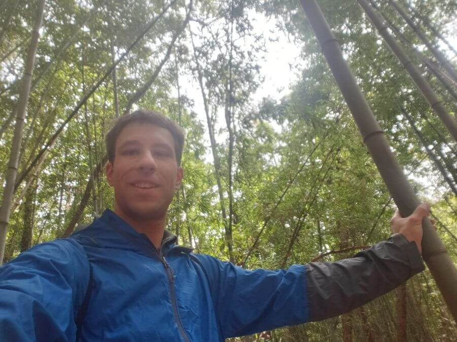 Nate holding a bamboo stalk